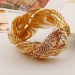 The Sophie bracelet is a braided gold bangle by Plunder Design